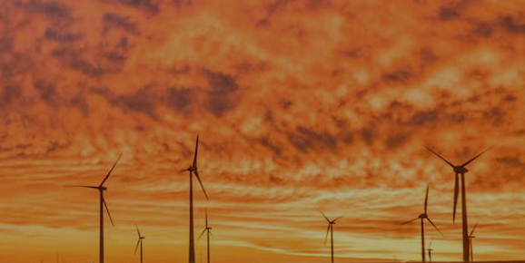 wind farm under red sky